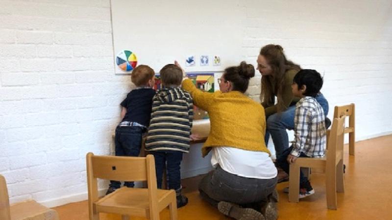 Kinderen en medewerkers doen een spelletje